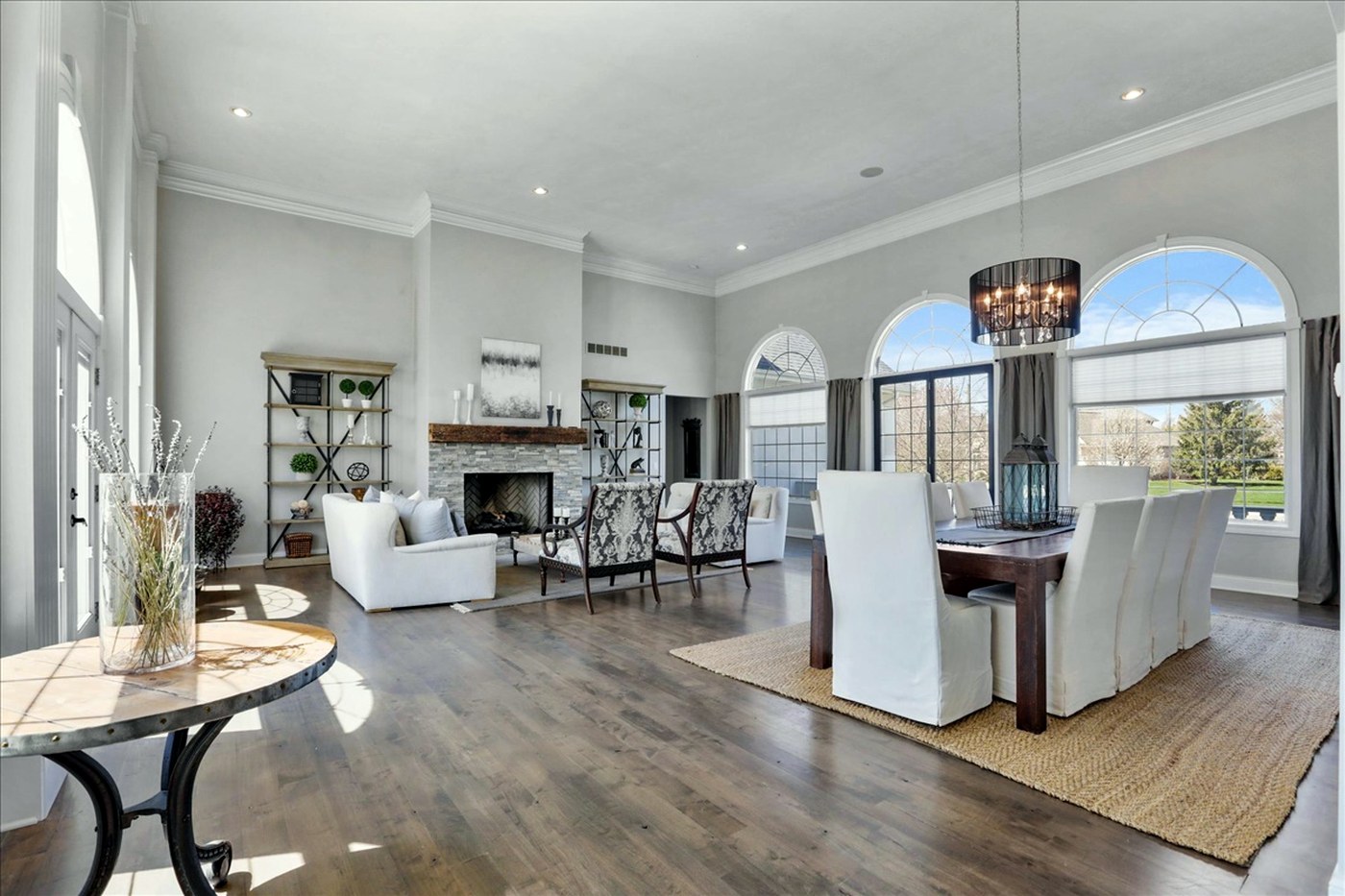Longwood great room and dining with soaring ceilings and arched windows
