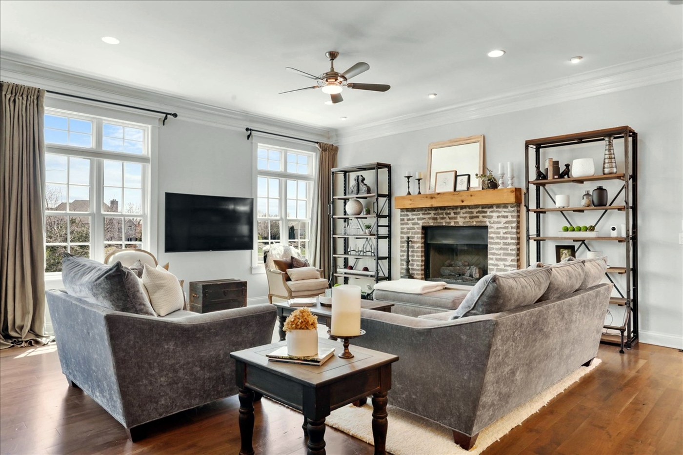 Longwood family room with brick fireplace and reclaimed wood mantel